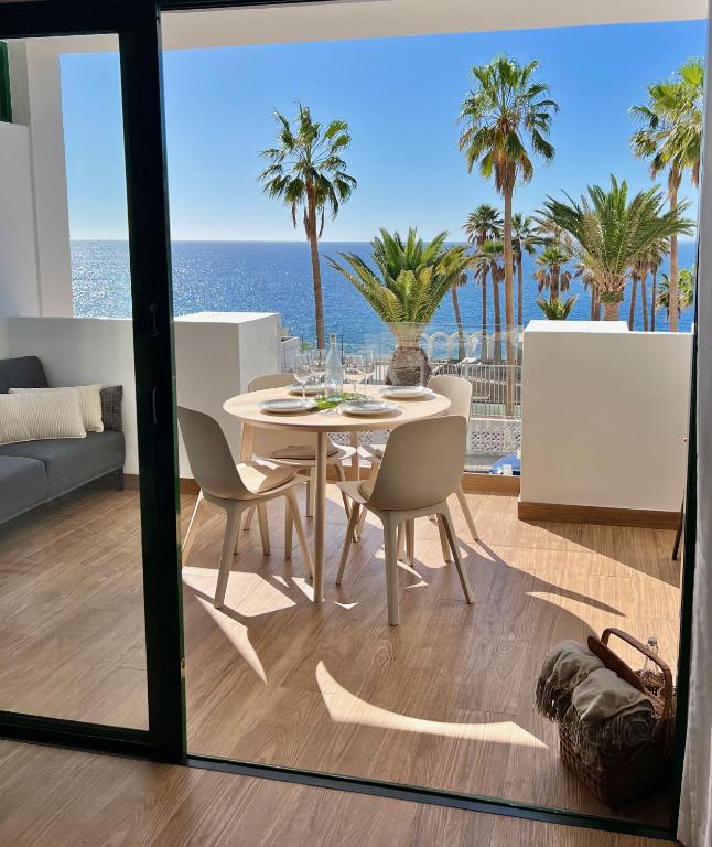 a dining room with a table and a view of the ocean at Callao Ocean View Luxury, air condition, wifi in Callao Salvaje