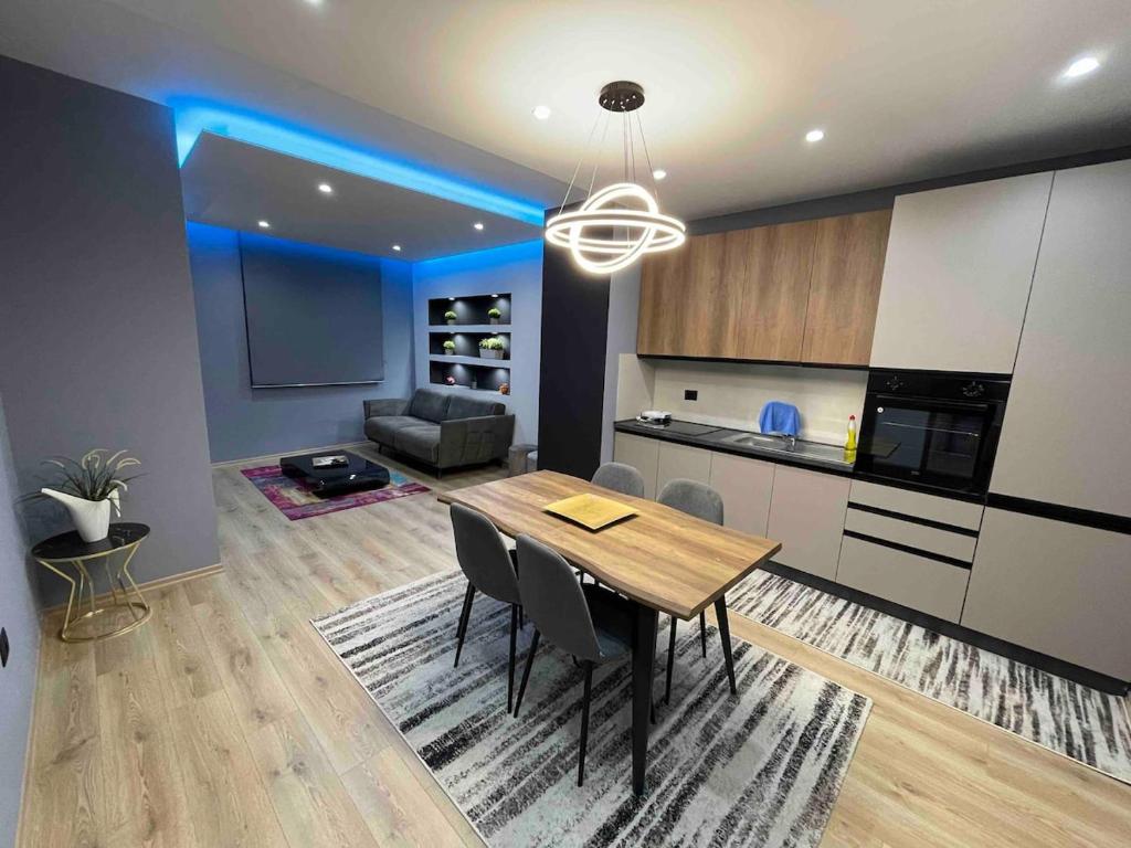 a kitchen and dining room with a table and chairs at Gold Apartment Tirana in Tirana