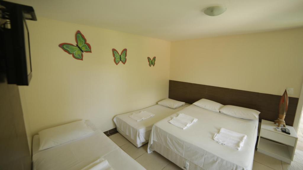 Giường trong phòng chung tại Pousada das Araras