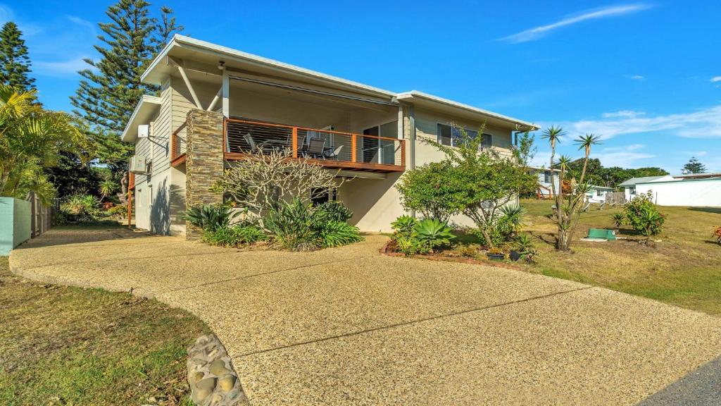 a house with a walkway in front of it at Wooli Waves in Wooli