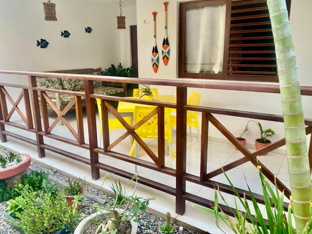 a wooden railing in a room with plants at Chalé Sertão e Mar in Canguaretama