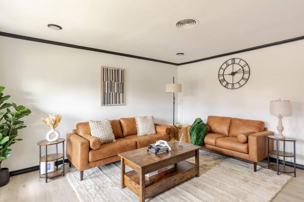 a living room with two couches and a table at Cozy 3 Bedroom House Near DFW in Bedford
