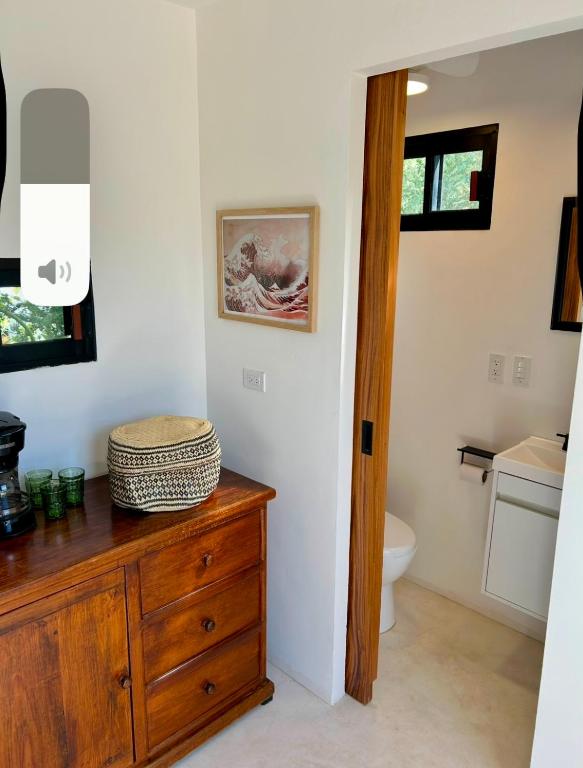 a bathroom with a wooden dresser and a toilet at Casita Palo Verde in San José del Cabo