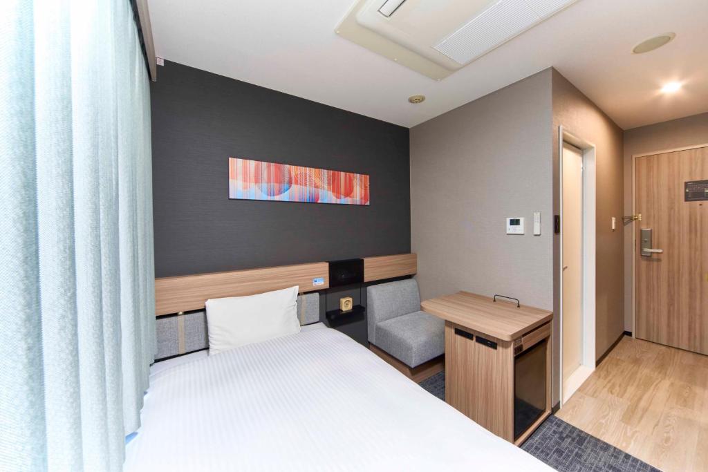 Postel nebo postele na pokoji v ubytování Washington R&B Hotel Umeda East