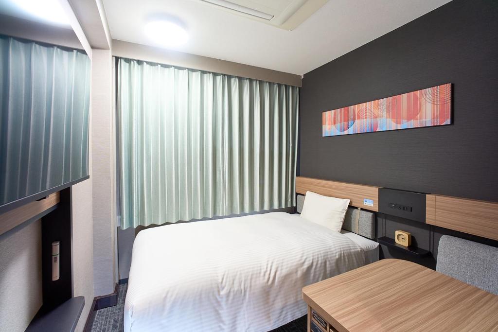 Postel nebo postele na pokoji v ubytování Washington R&B Hotel Umeda East