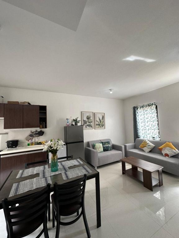 a living room with a table and a couch at Almond drive 2BR Townhouse Near SRP Nustar Talisay in Talisay