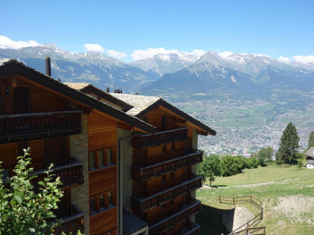 a building with a view of the mountains at Cozy Apartment With Valley Views in Veysonnaz
