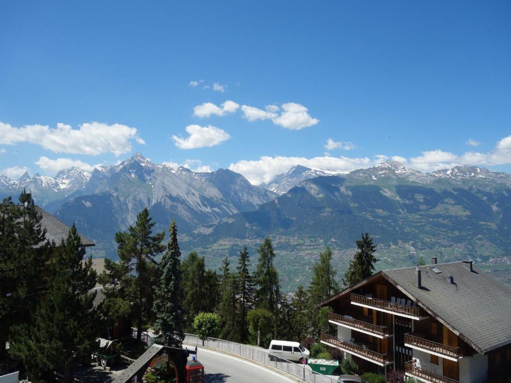 a view of a mountain range with a building at Centrally-located apartment in Veysonnaz in Veysonnaz