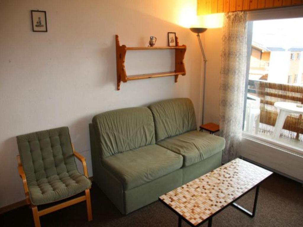 a living room with a couch and a chair at Studio in Veysonnaz near Ski Lift in Veysonnaz