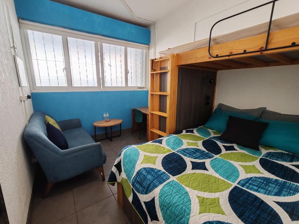 a bedroom with a bunk bed and a chair at Apartamento zona 1 in Guatemala