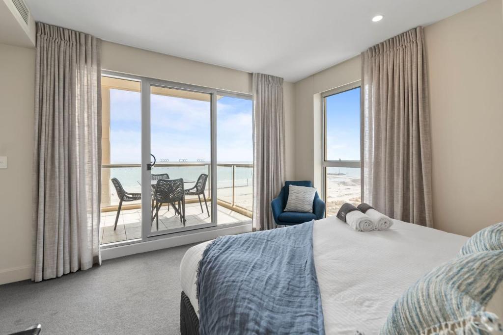 a bedroom with a bed and a view of the ocean at Belle Escapes - Ocean Views at the Bay in Glenelg