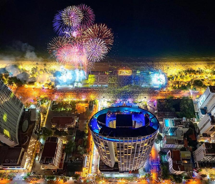 an aerial view of a city with fireworks at night at Panorama Luxury Beach Front Residences in Nha Trang