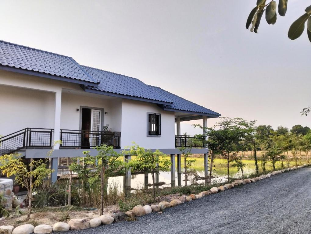 a house on the side of a road at Baksaei Retreat Ricefield Villas in Kampot