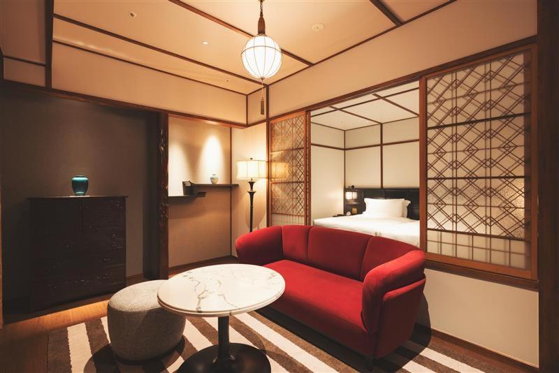 Postel nebo postele na pokoji v ubytování Mampei Hotel