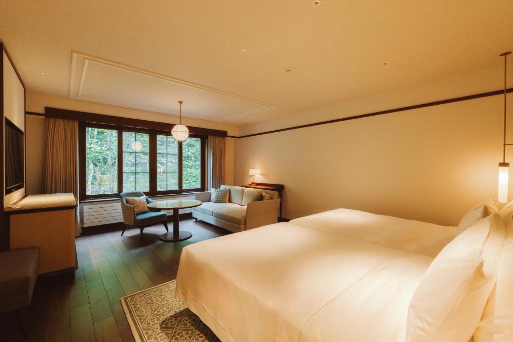 Postel nebo postele na pokoji v ubytování Mampei Hotel