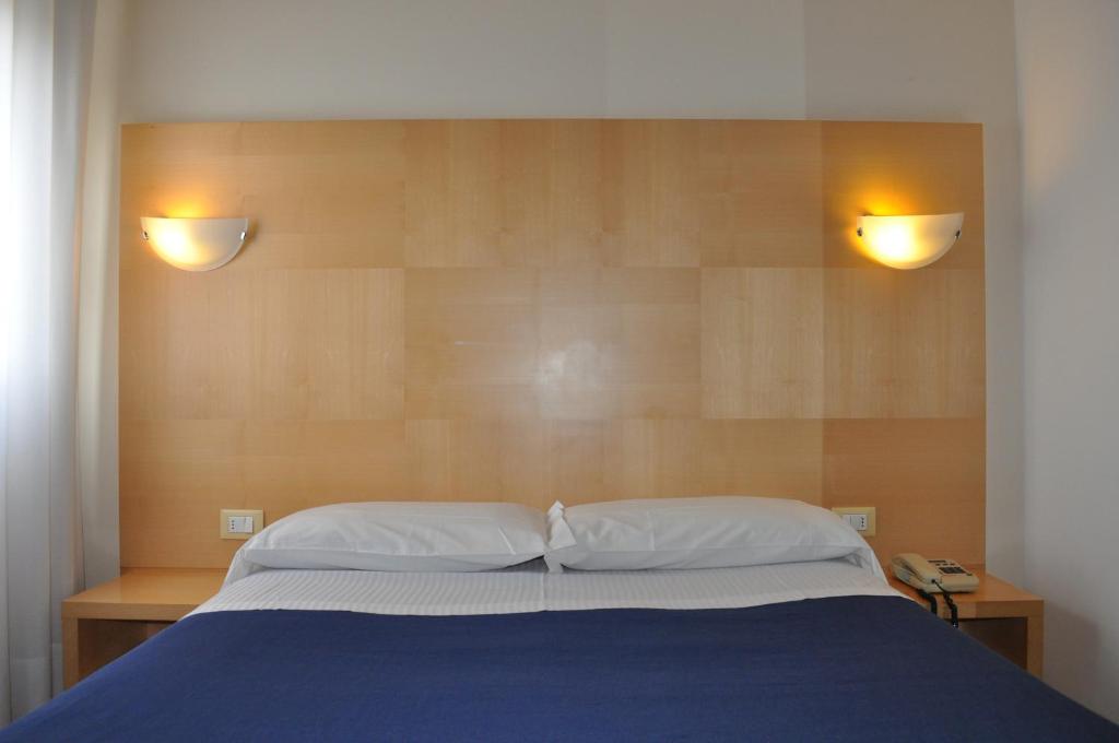 Postel nebo postele na pokoji v ubytování Hotel Igea
