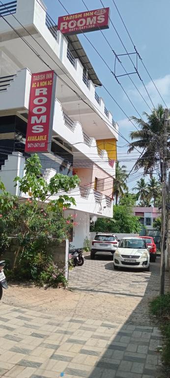 a car parked in front of a building at Tabish INN in Trivandrum
