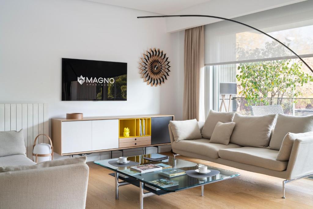 a living room with a couch and a table at Magno Apartment Ramón Carande- Private Parking included in Seville