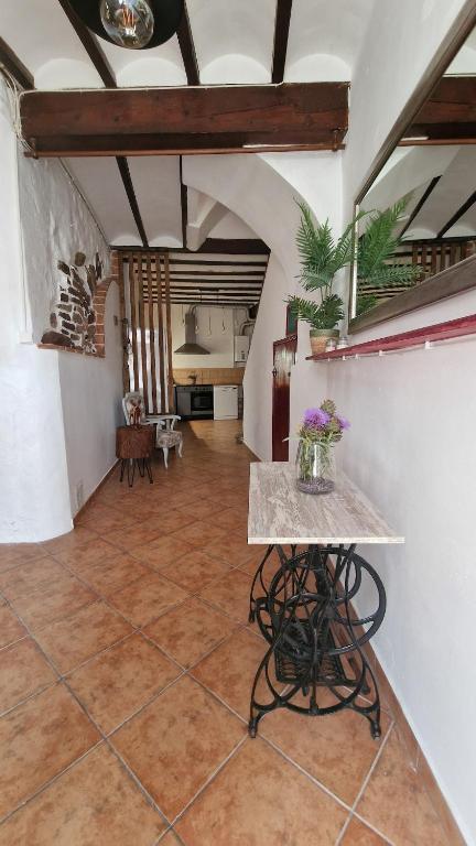 a room with a table with flowers on it at La Replaceta in Segorbe