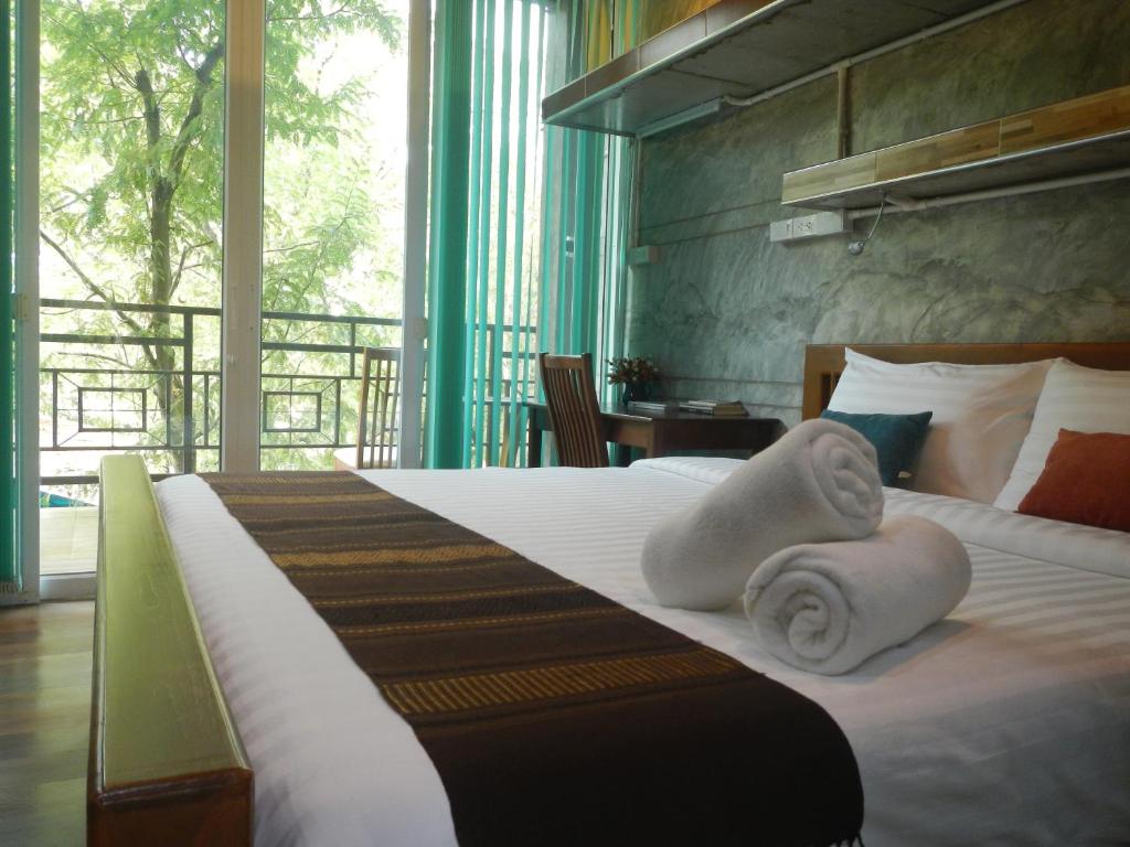Postel nebo postele na pokoji v ubytování Loei Huen Hao Hug Home&Resort