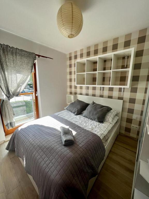 a bedroom with a bed with a pillow on it at Premium Gniezno in Gniezno