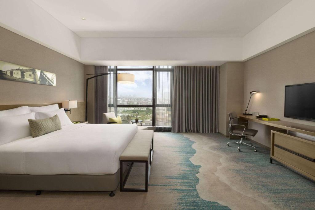Postel nebo postele na pokoji v ubytování Wyndham JinJiang Hotel
