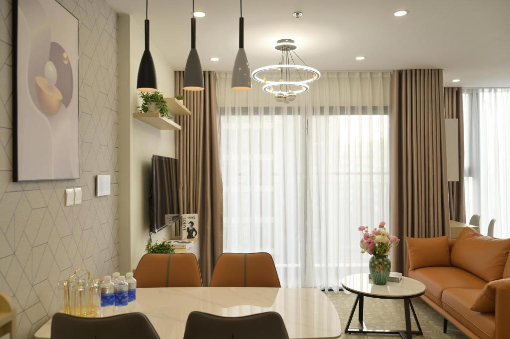 a living room with a couch and a table at Luxury I3 Imperia Smart City Hanoi - Free Gym - 30 percent off for one month up in Phú Thú