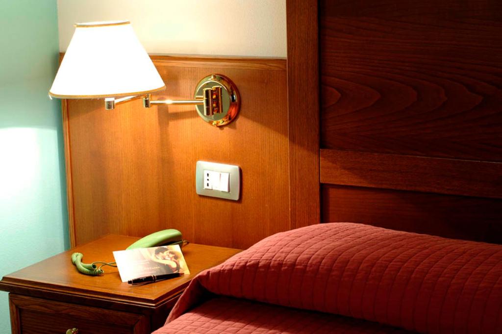 Postel nebo postele na pokoji v ubytování Corte Castelletto