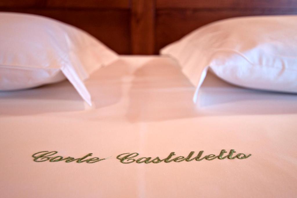Postel nebo postele na pokoji v ubytování Corte Castelletto