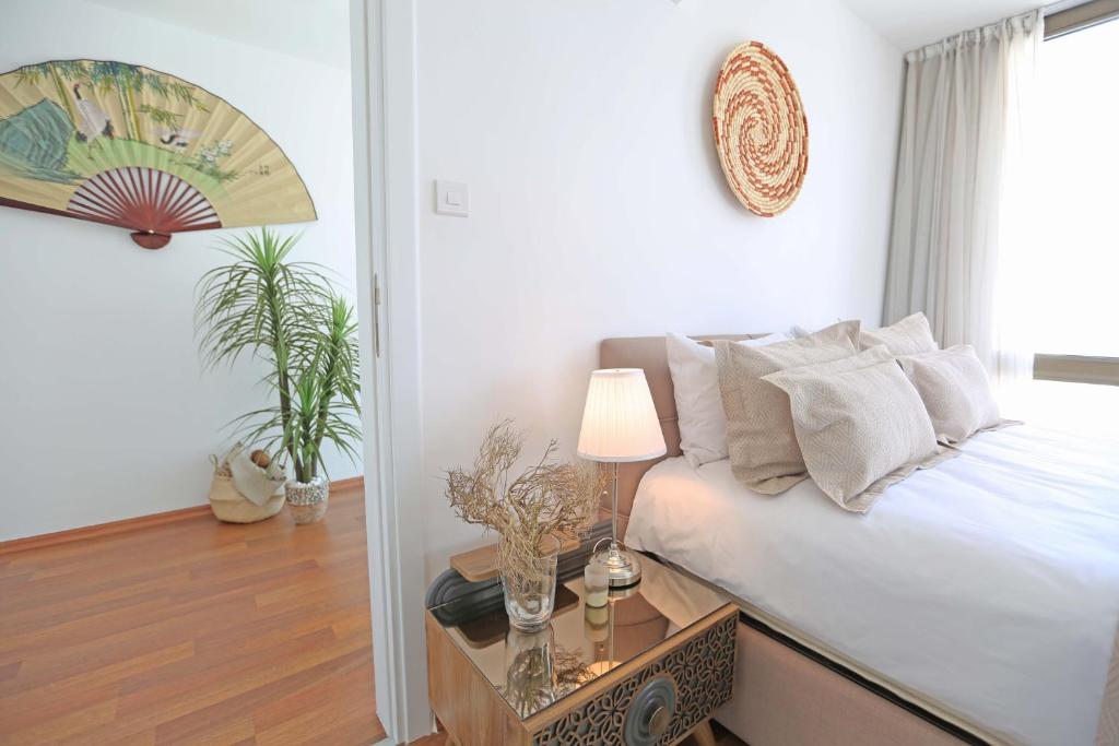 a bedroom with a bed and a table with a lamp at Magic Vista Exclusive Luxury Duplex by HolidayKeys in Kérynia