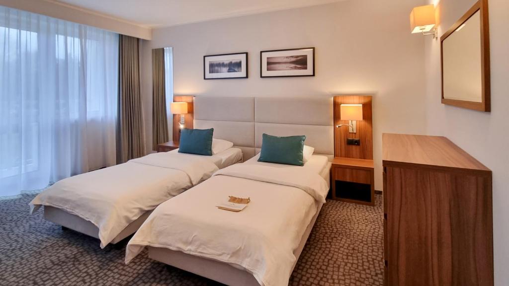 Posteľ alebo postele v izbe v ubytovaní Hotel Wolin