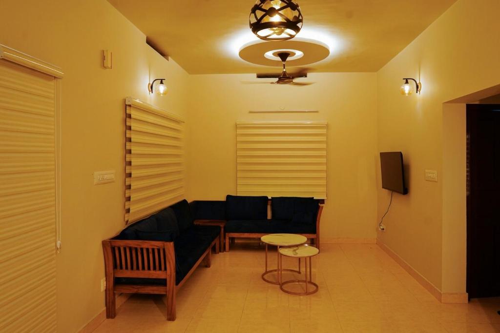 a living room with a couch and a table at Sarovaram -Beautiful Riverfront Villa Kochi in Ernakulam