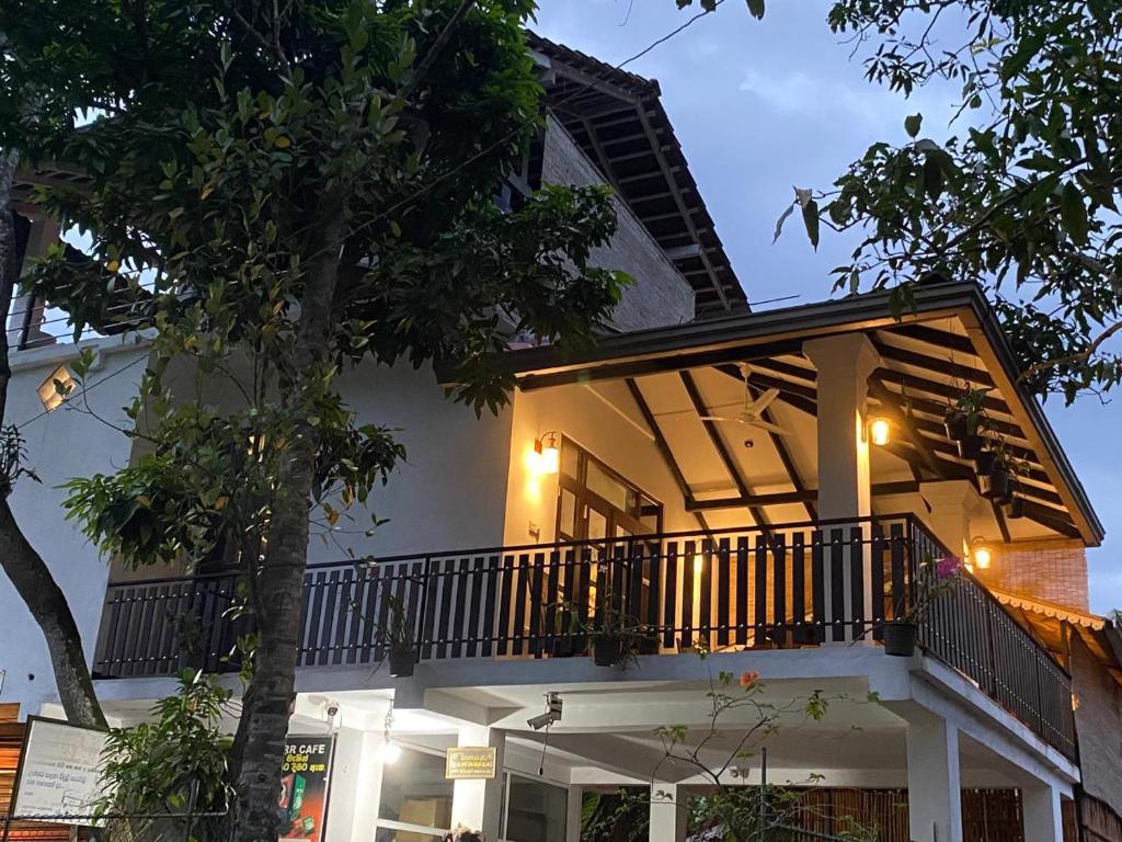 a building with a balcony with lights on it at Little Villa in Habaraduwa