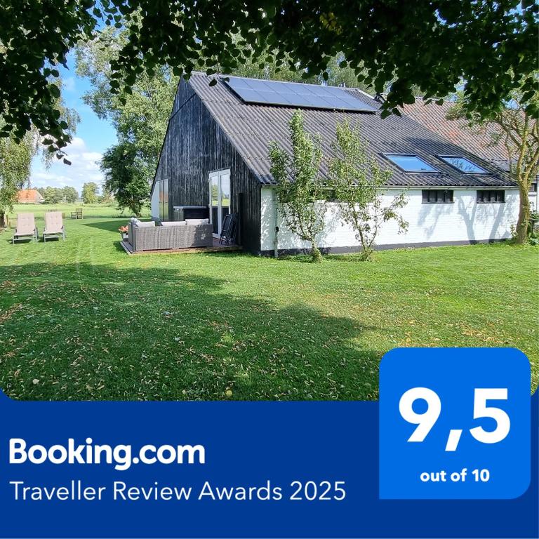 a barn with a sign that says travel review awards at Slapen bij Bonanza in Bantega