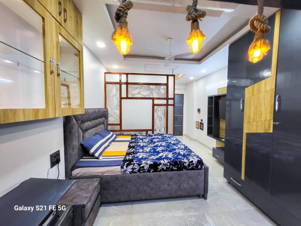 a bedroom with a bed and a tv in it at VacationBuddy Superb Furnished Studio Apartment 720 in West Delhi in New Delhi