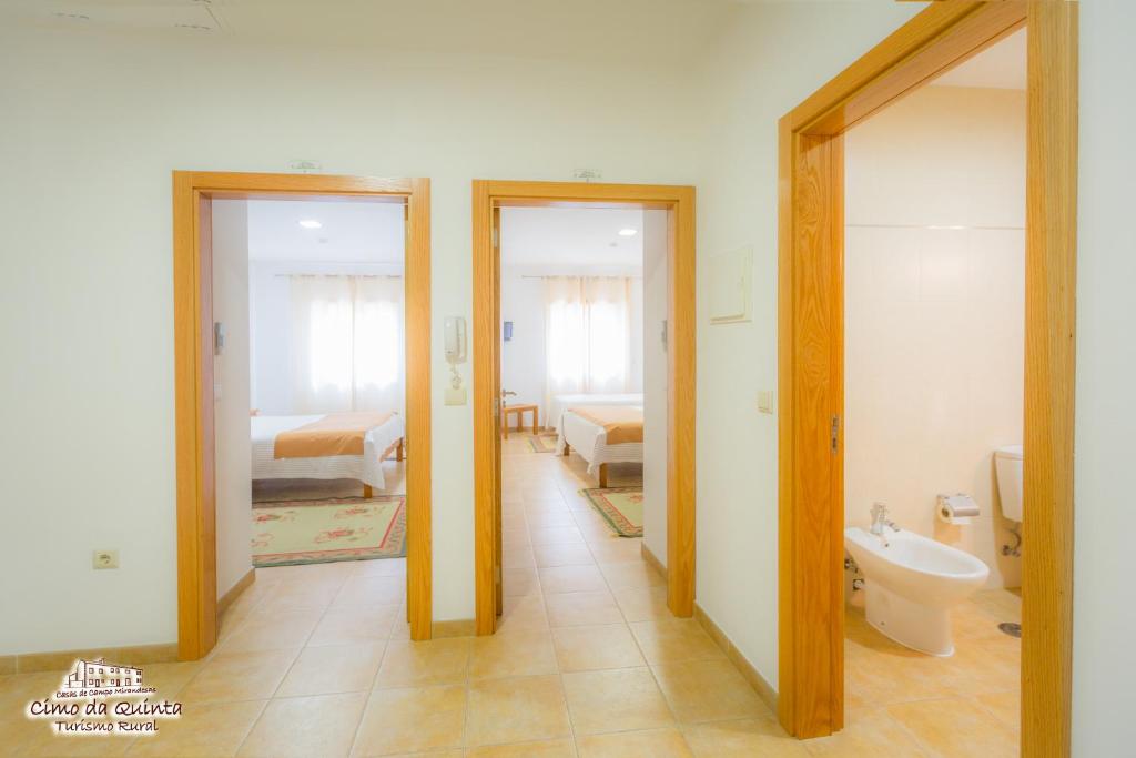 a bathroom with two doors and a bathroom with a toilet at Casas Campo Cimo da Quinta in Miranda do Douro