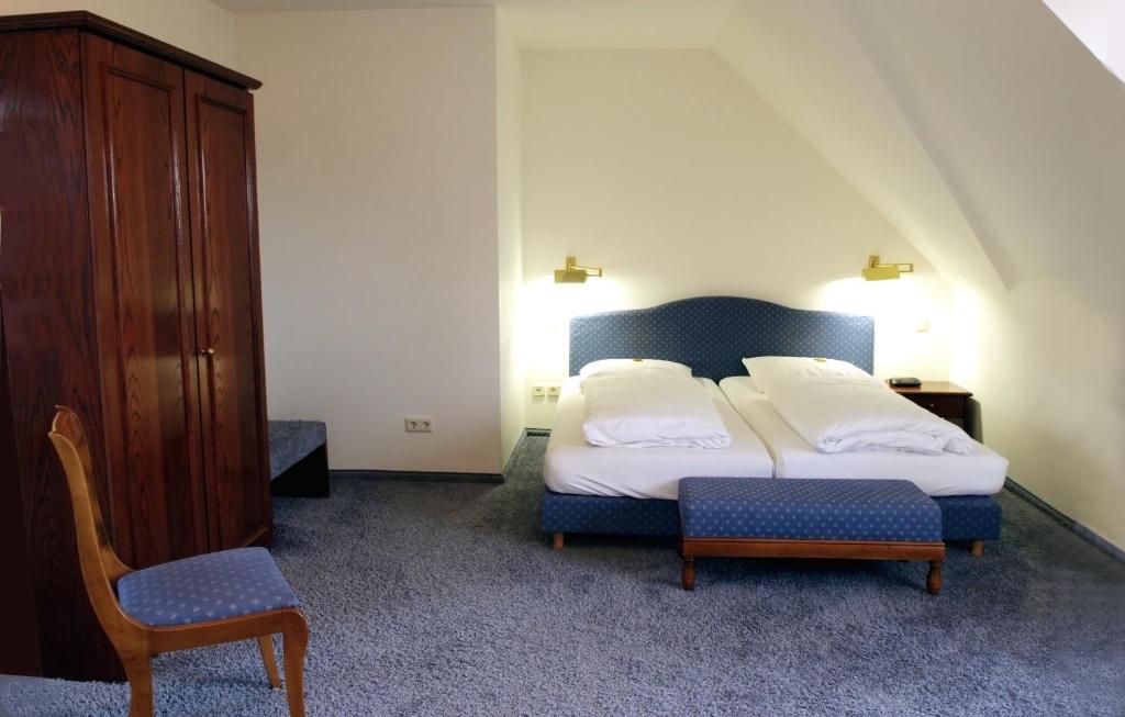 Postel nebo postele na pokoji v ubytování Hotel & Gasthaus Backmulde