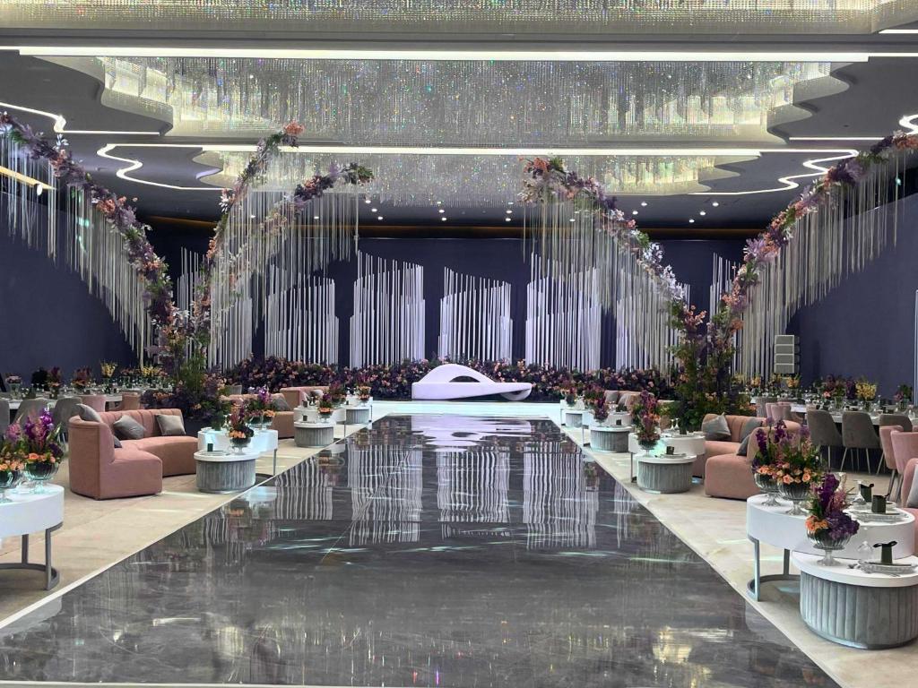 a rendering of a banquet hall with tables and flowers at Pullman Doha West Bay in Doha