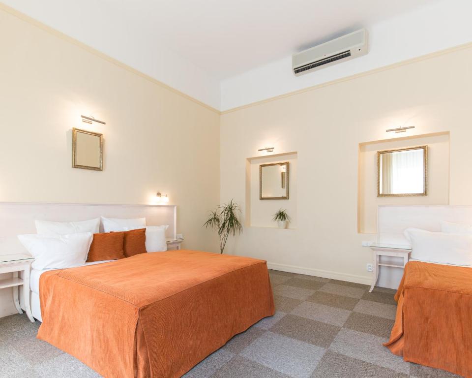 Postel nebo postele na pokoji v ubytování Unitas Hotel