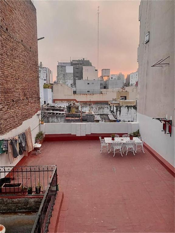 a patio with tables and chairs on a building at Beautiful stay in Abasto-Recoleta-O-P in Buenos Aires