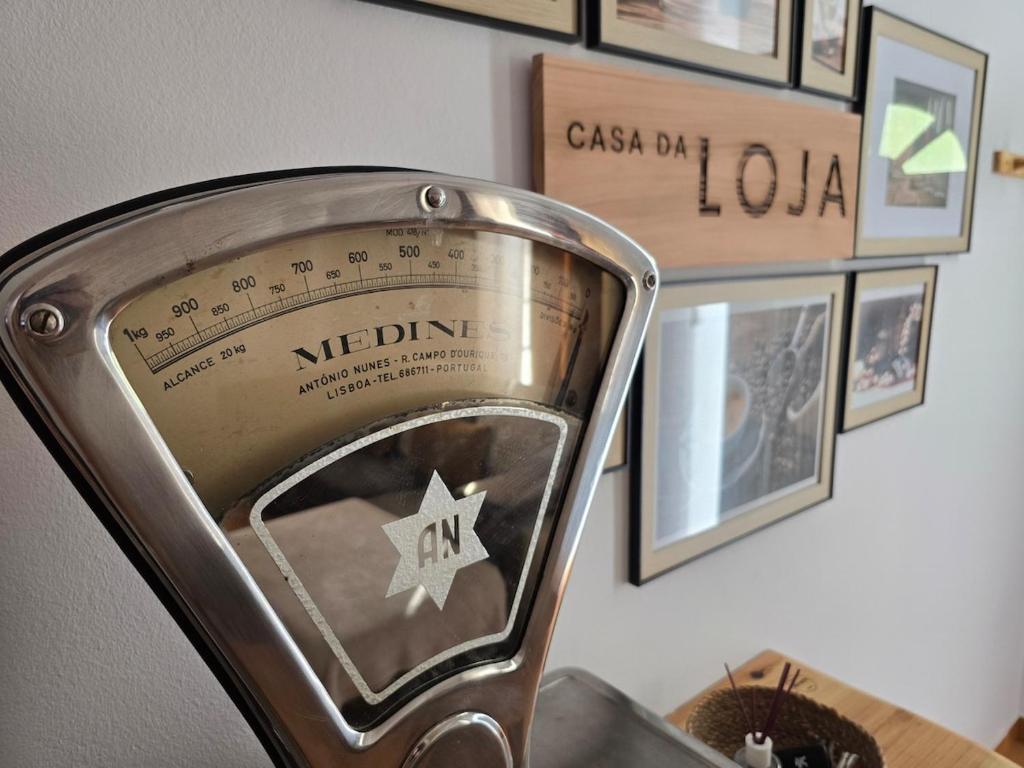 a close up of a metal chair with pictures on the wall at A Casa da Loja in Lagoa