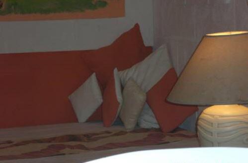 a bedroom with a bed with pillows and a lamp at The Legend Garden Condos in Saint Peter