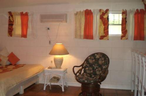 a bedroom with a bed and a chair and a lamp at The Legend Garden Condos in Saint Peter