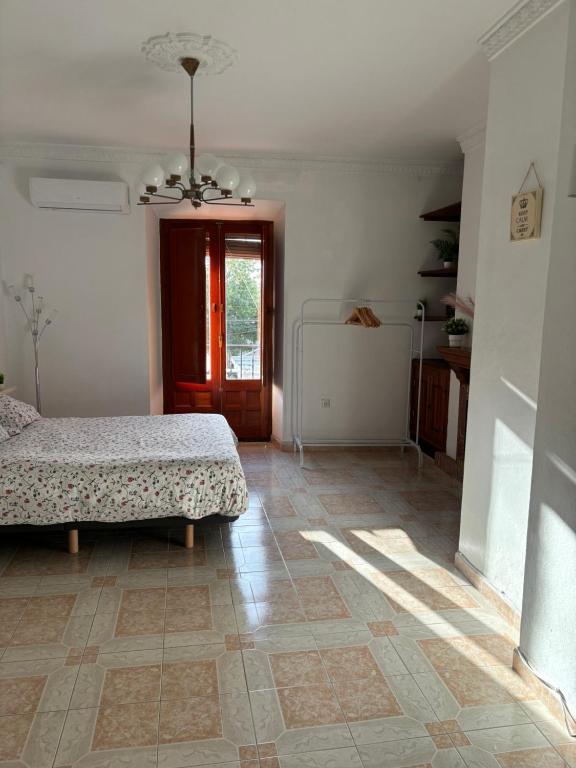a bedroom with a bed and a floor at Alma de Estepona junto al mar in Estepona
