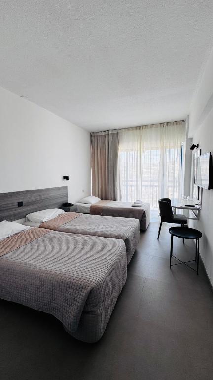 Postel nebo postele na pokoji v ubytování Navarria Blue Hotel