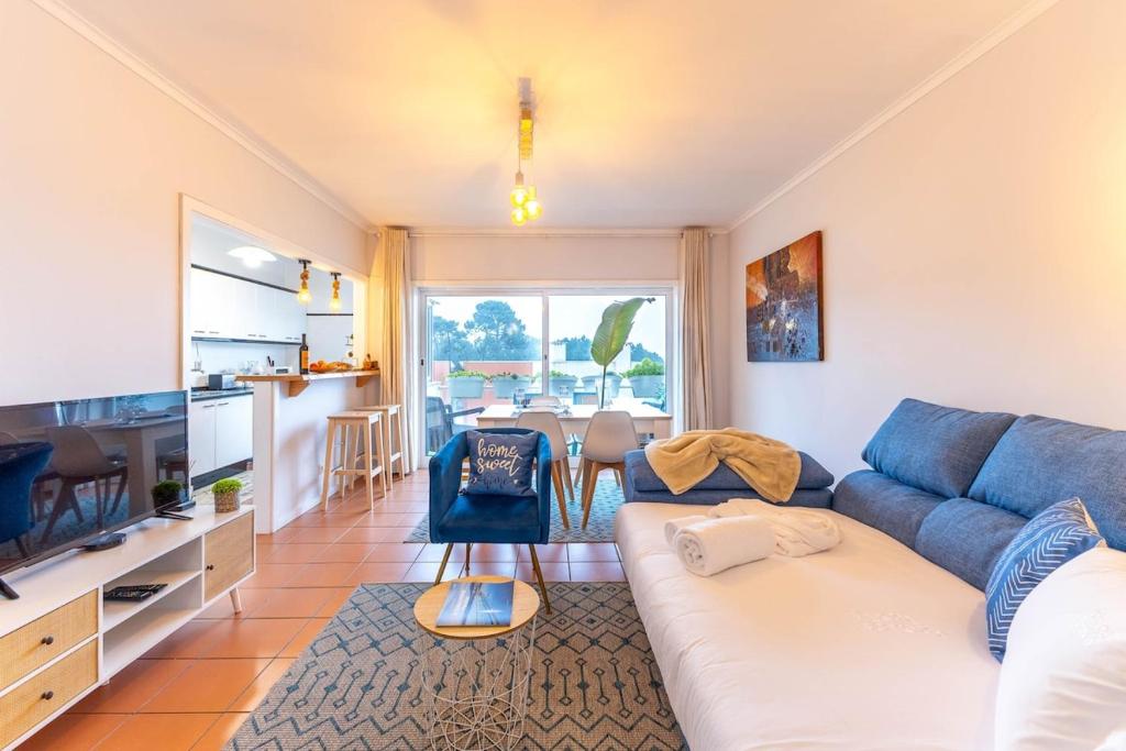 a living room with a couch and a television at Divine Waves Duplex by Portugal Active in Viana do Castelo