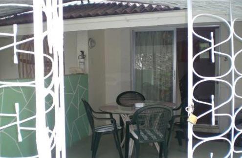 a table and chairs on a porch with a table and chairs at The Legend Garden Condos in Saint Peter