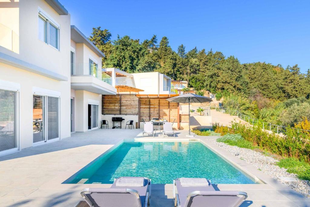 a swimming pool in the backyard of a house at Villa Anastazia in Koskinou
