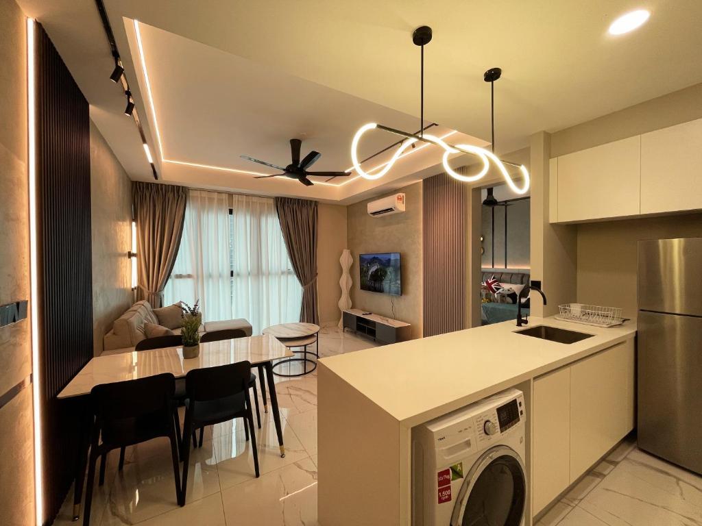 a kitchen and living room with a washer at Alfa Bangsar by The Homez in Kuala Lumpur