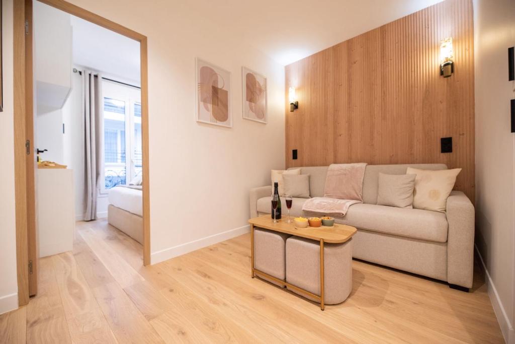 un salon avec un canapé et une table dans l'établissement CIA - Rue de l'Étoile Haven, 4P, à Paris